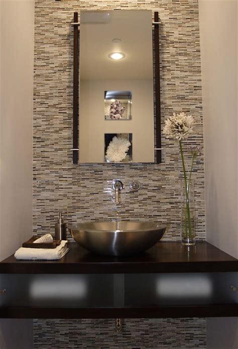 Taupe grasscloth wallpaper accented with white board and batten covers the walls of this gorgeous powder room featuring a triangle brass mirror hung over a white single washstand fitted with a white porcelain sink and a gold modern faucet. Powder Room - Modern - Powder Room - Los Angeles - by ...