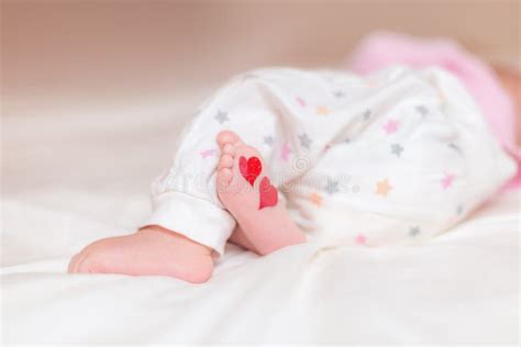 Baby Foots With Hearts On Their Feet A Newborn Baby Is Lying On Stock