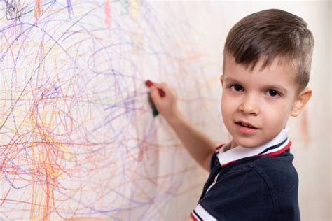 Premium Photo Boy Draws On The Wall With Colored Chalk The Child Is