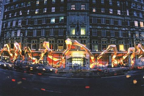 An Artistic Display In Front Of A Large Building At Night With Lights