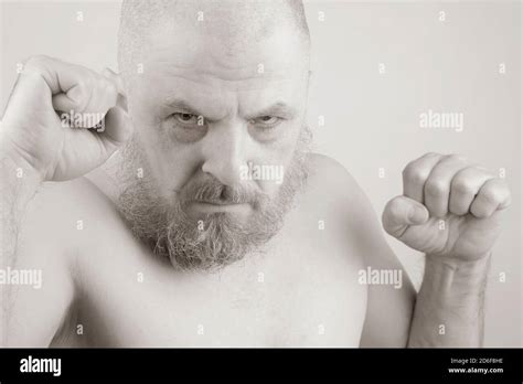 Aggressive Bearded Man With Clenched Fists In Black And White Photo