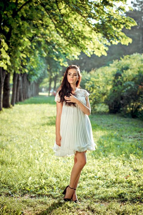 Beautiful Girl In A White Dress On Nature Stock Photo