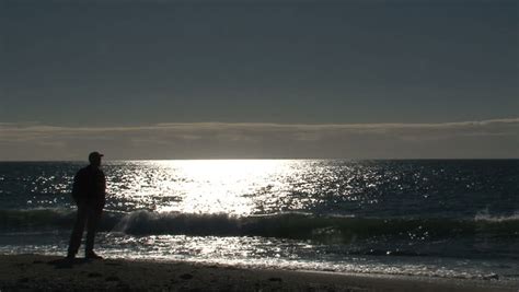 Man Standing On The Beach Watching The Sunset Stock Footage Video