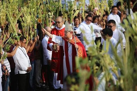 Download palm sunday stock photos. Catholic devotees troop to churches, wave palaspas on Palm ...