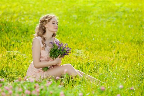 Girl With A Bouquet Sitting On Green Grass Wallpapers And Images Wallpapers Pictures Photos