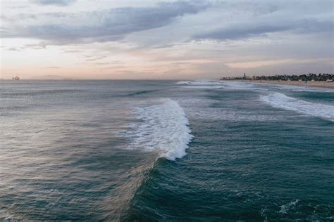 Huntington Beach Pier Ocean Waves Crashing On Shore During Daytime