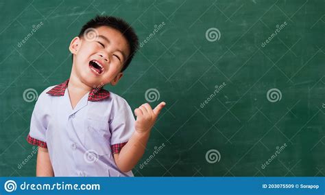 Child From Kindergarten In Student Uniform Smiling On Green School