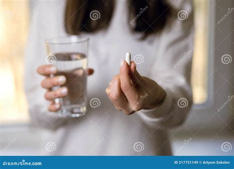 A Depressed Woman Drinks Antidepressants A Young Woman Holds A Pill