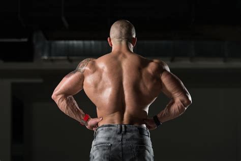 Premium Photo Muscular Man Flexing Back Muscles Pose