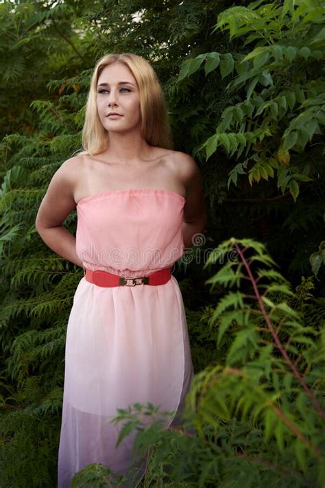 Blonde Model Poses In Park Wearing Pink Strapless Dress Stock Image Image Of Fashion Blond