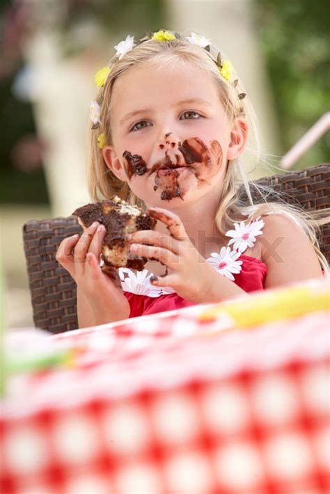 messy girl eating chocolate cake stock image colourbox