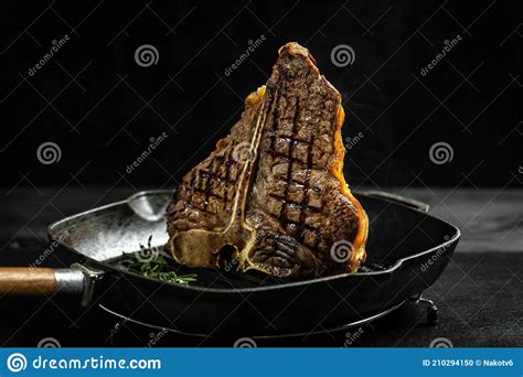 Gourmet T Bone Steak Cooked On Grill In American Meat Restaurant Dry