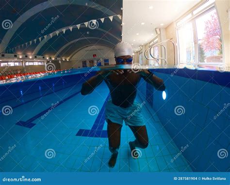 Sportsman Is Practicing Total Immersion Swim Technique In Pool Stock