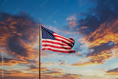 An American Flag Against A Blue Sky On An Old Rusty Flagpole Stock