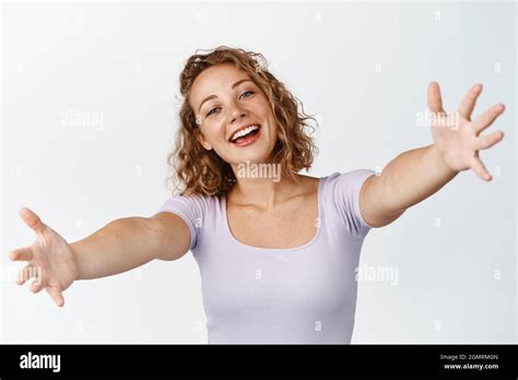Happy Blond Girl Reaching For Hug With Big Friendly Smile Waiting For