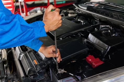 Mechanic Checking And Fixing A Broken Car In Car Service Garage With