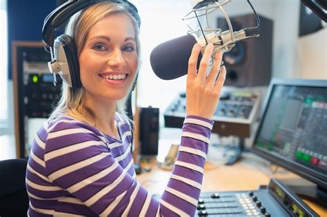 Happy Young Female Radio Host Broadcasting In Studio Photo Premium