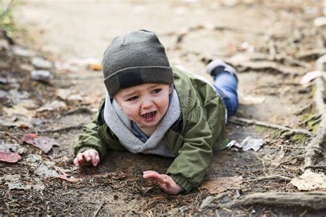 Boy Hurt After Falling In The Forest Sad And Unhappy Child Crying Stock