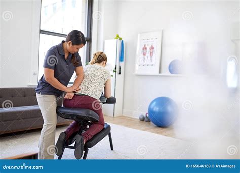 Chinese Woman Massage Therapist Giving A Neck And Back Pressure Stock Image Image Of