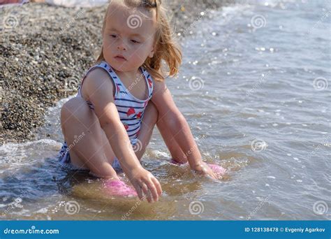 Cute Baby Girl Is Playing On Sea Cost With Pebble Slow Motion Video