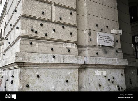 A Wall Of A Building Where You Can Still See The Bullet Holes Of The