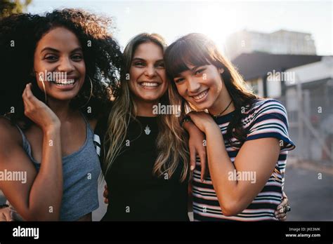 Outdoor Shot Of Three Young Women Having Fun On City Street
