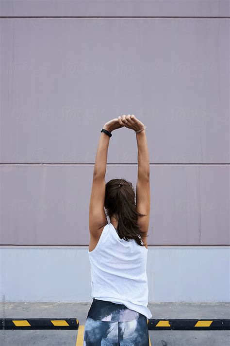 Sportswoman Stretching Arms By Stocksy Contributor Ivan Gener Stocksy