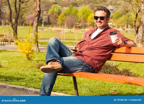 Handsome Young Man Sitting In Park On Wooden Bench Stock Photo Image