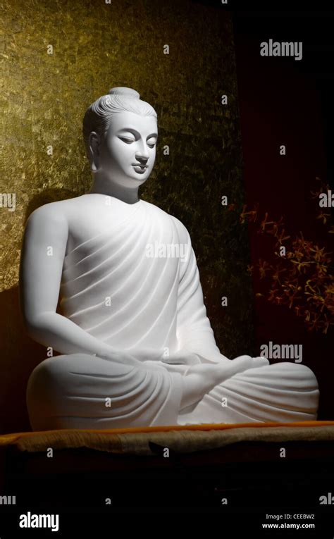 White Buddha Statue Sitting In Lotus Position Meditation Stock Photo