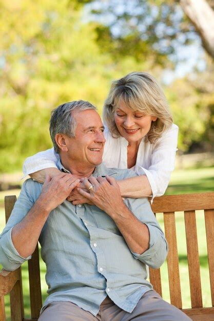 Premium Photo Senior Woman Hugging Her Husband Who Is On The Bench