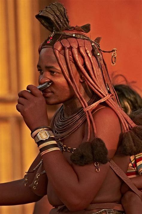 Himba Tribe Girl Smelling A Phone Street Observation In Small Town Opuwo In Northern Namibia