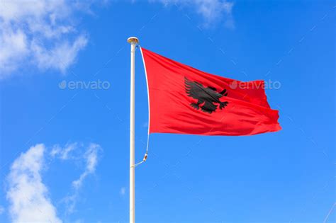 Albania Flag Albanian Flag On A Pole Waving On Blue Sky Background