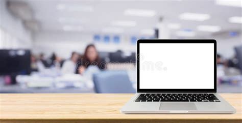 Laptop With Blank Screen On Desk Table With Blur Office Stock Photo