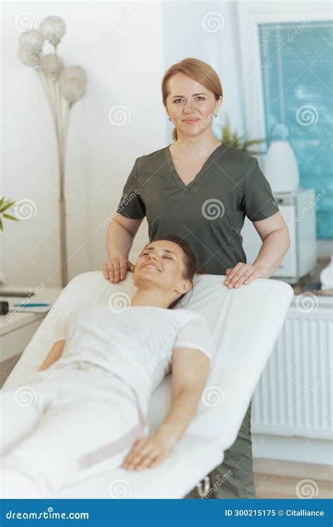 Happy Massage Therapist Woman In Massage Cabinet With Client Stock Image Image Of Employee