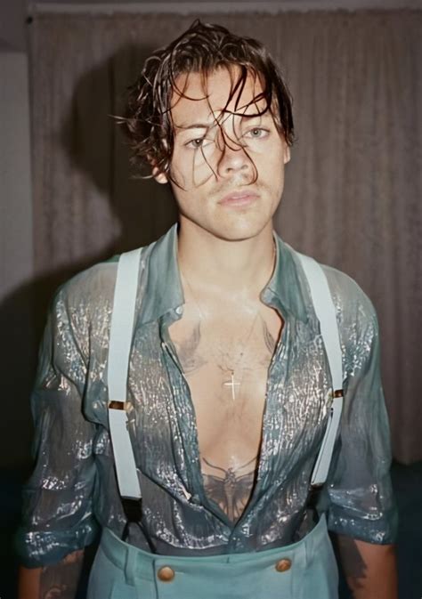 A Man With Wet Hair And Suspenders On