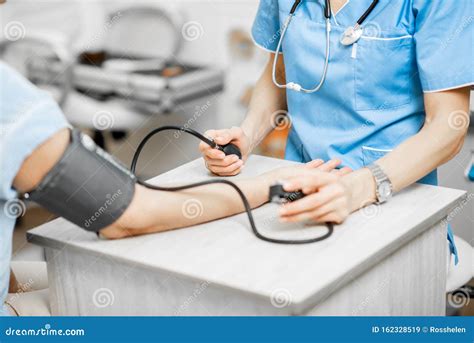 Nurse Measuring Blood Pressure Of A Senior Patient Stock Image Image