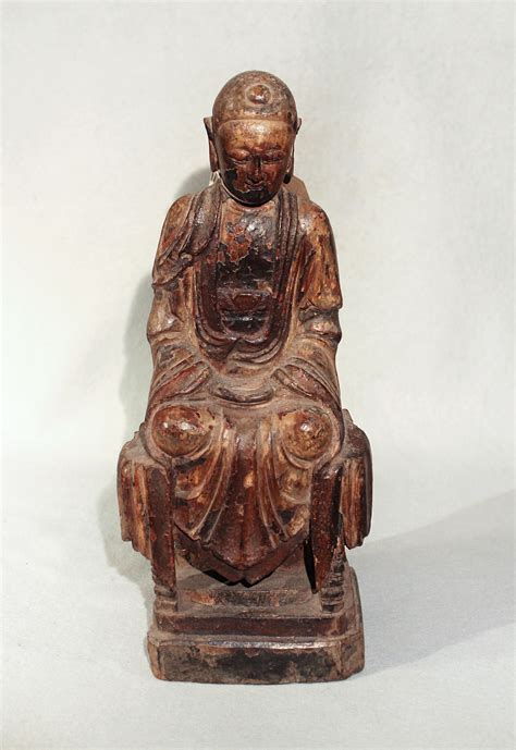 A Chinese Carved And Polychrome Painted Wood Figure Of A Seated Buddha