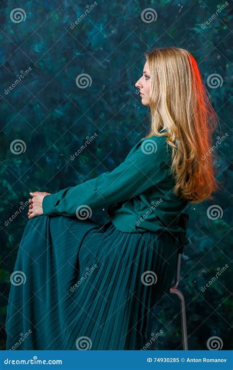 Blonde Girl On A Green Background In A Long Green Dress Stock Image