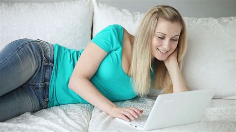 person relaxing on sofa with laptop smiling stock footage sbv 303972472 storyblocks