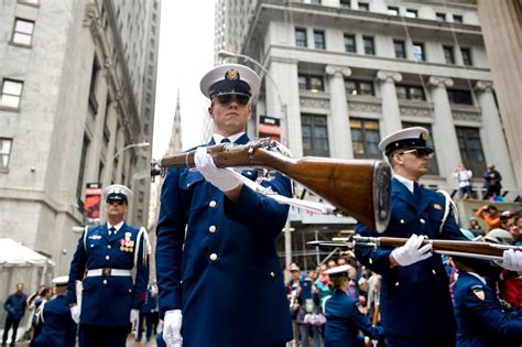 A Member Of The Coast Guard Ceremonial Honor Guard Silent Drill Team Performs A Rifle Movement