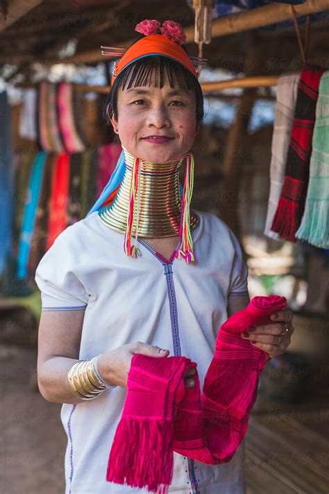 A Long Neck Woman Showing A Silk Handmade Scarf In A Shop By Stocksy