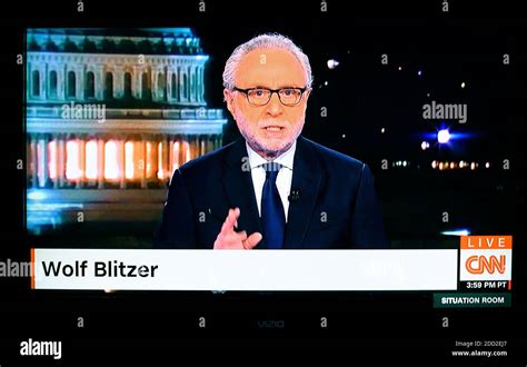 A Television Screenshot Of Cnn News Anchor Wolf Blitzer Delivering The