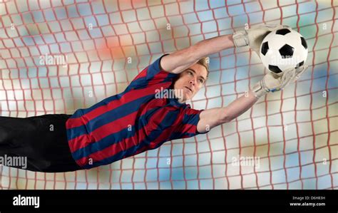 Soccer Player Catching Ball In Air Stock Photo Alamy