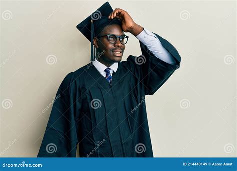 Handsome Black Man Wearing Graduation Cap And Ceremony Robe Smiling