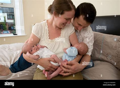 Parents Holding Identical Twin Baby Boys Premature Babies Stock Photo