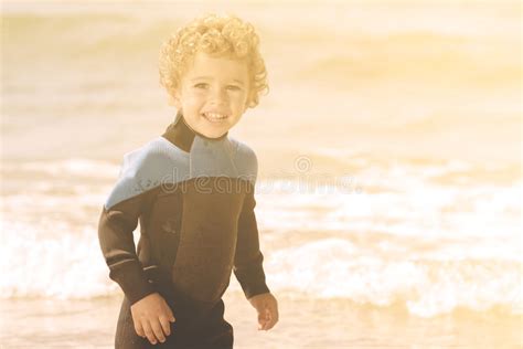 Portrait Of Playful Boy On The Beach With Sea On Background Stock Photo