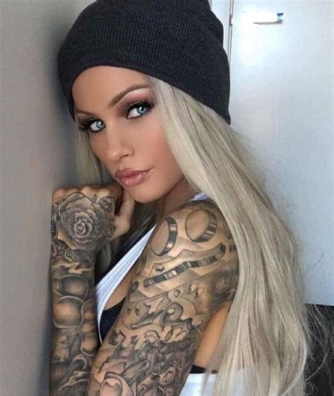 A Woman With Tattoos On Her Arms And Arm