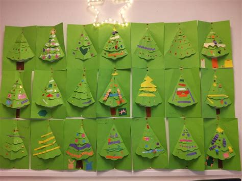 A Group Of Christmas Trees Made Out Of Green Paper On A White Wall With