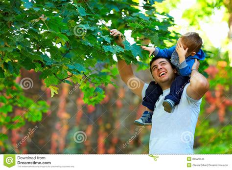 Father And Son Having Fun Among Colorful Nature Stock Photo Image Of