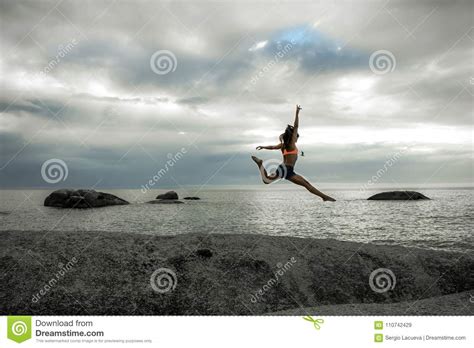Woman Jumping On A Rock At Sunset On Bakovern Beach Cape Town Stock Image Image Of Cape
